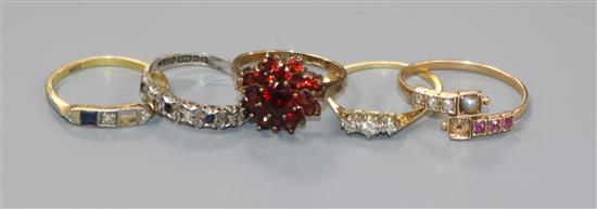 An 18ct gold ring (lacking one stone) and four yellow metal gem set rings including two 9ct.